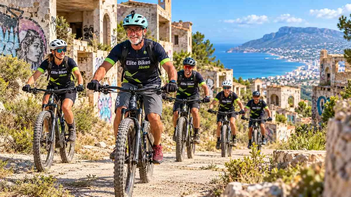 Elite Bikes Jávea e-MTB group riding through the Dénia ghost town with Mediterranean coast views
